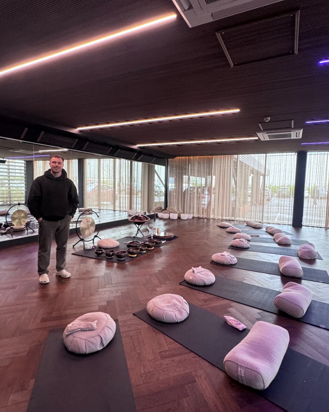 Ryan in a studio set up for a sound bath with gongs and singing bowls